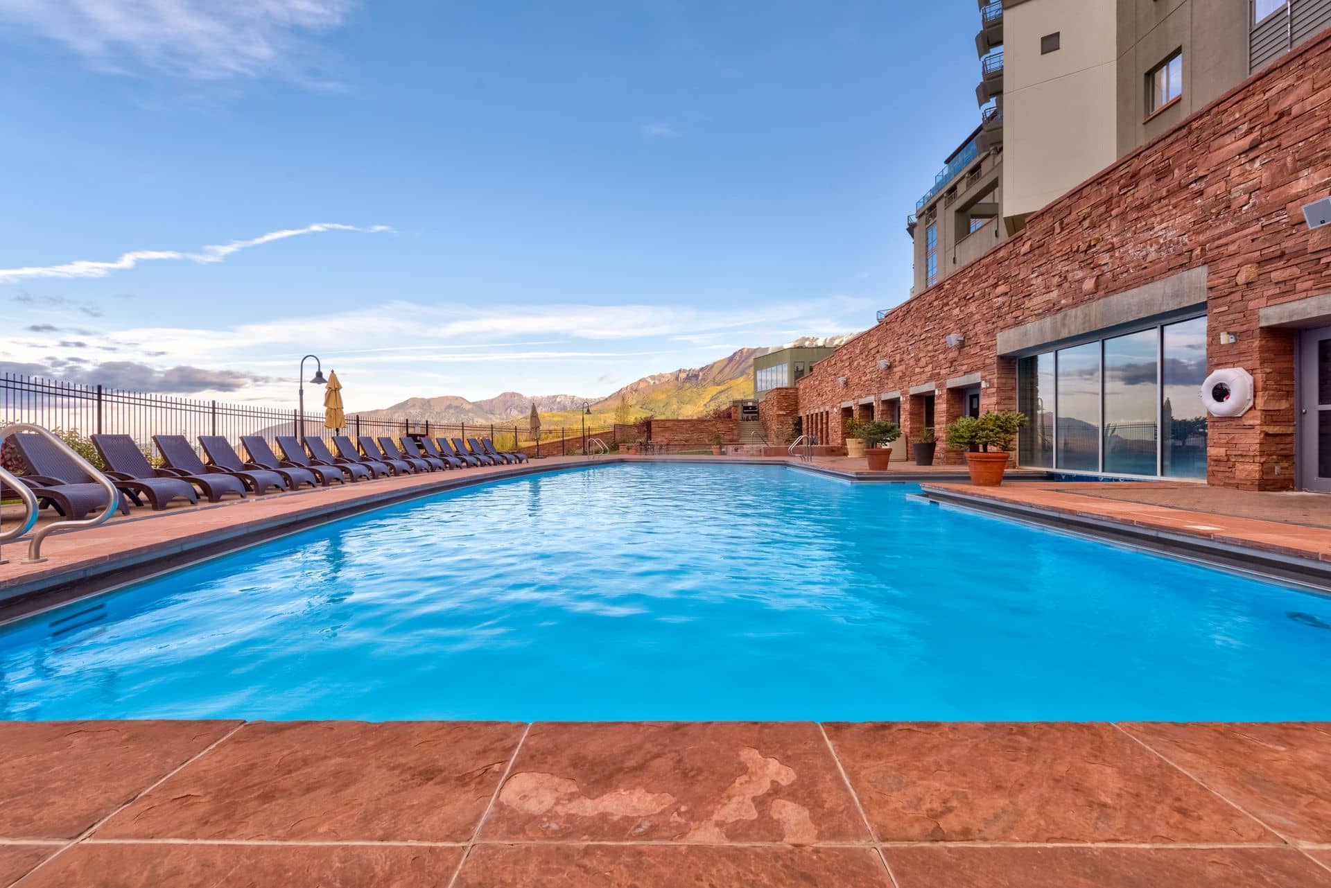 The outdoor heated pool at The Spa at The Peaks with mountain views from Mountain Village